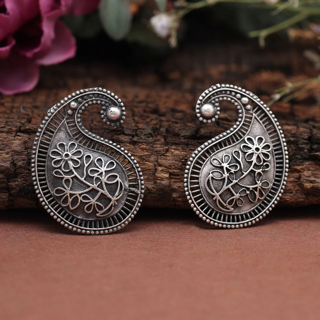 ambiya shaped oxidized earrings in silver tone